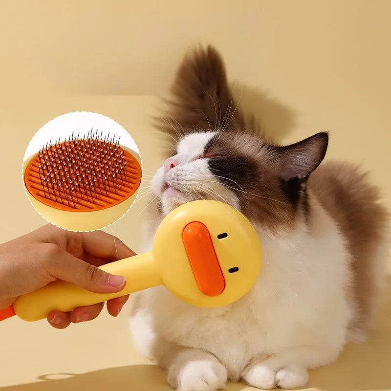 Small yellow duck-shaped pet grooming comb with open needle brush for cats and dogs