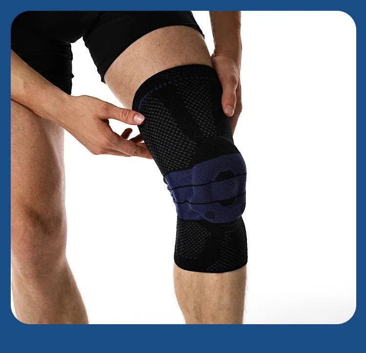Adult black and blue sports knee pad made of nylon and spandex, shown on a knee.
