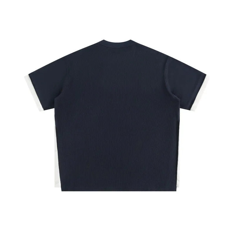 Loose fit grey waffle knit t-shirt with retro alphabet embroidery on the front.