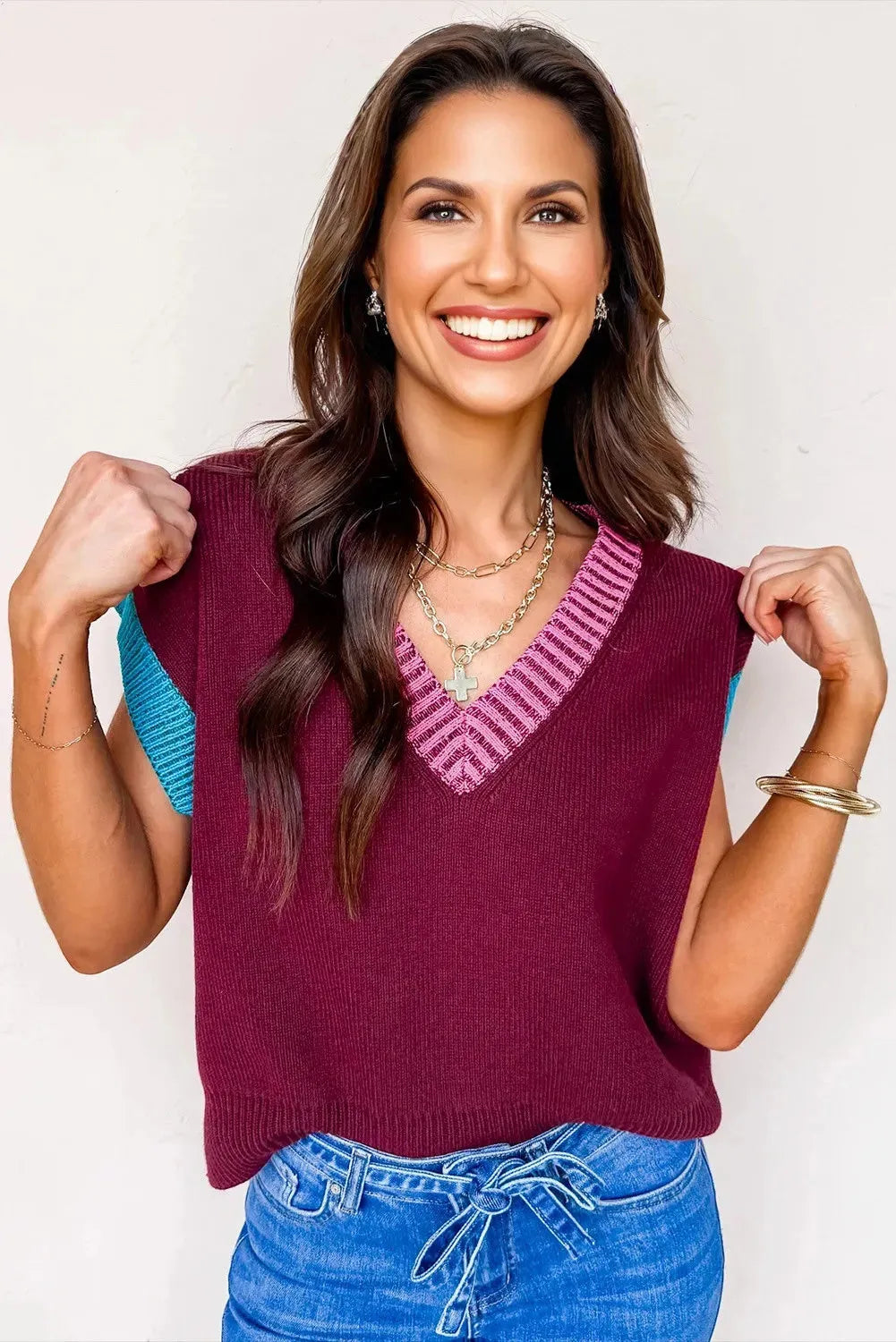 Burgundy loose longline women's sweater with V neckline and cuffed short sleeves with contrast trim.