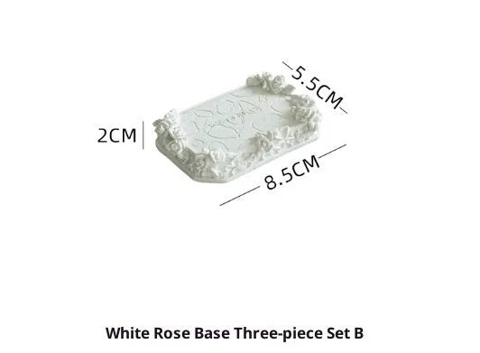 White gypsum rose ring storage tray with five style options shows a rose-shaped holder on a table