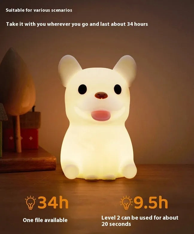 Soft silicone USB night light with dimmer in a cartoon animal design on a bedside table.