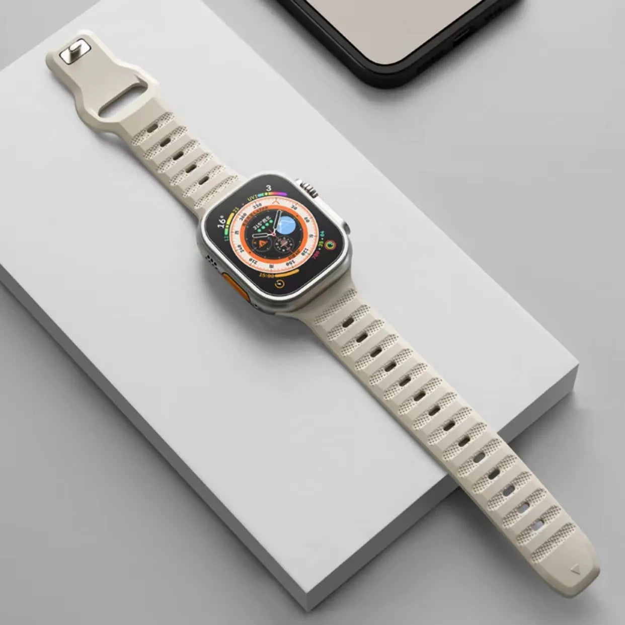 Fluoro rubber Apple Watch replacement strap with T buckle in one of six colours on a wrist.