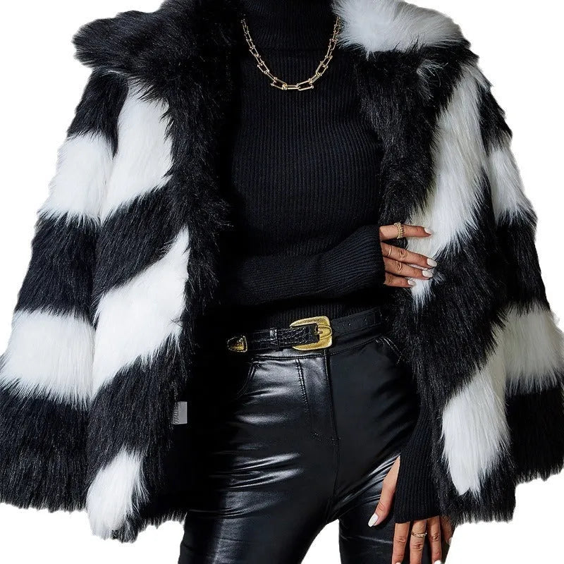 Women's grey faux fur coat with black contrast lapel and a large detachable faux fur collar.