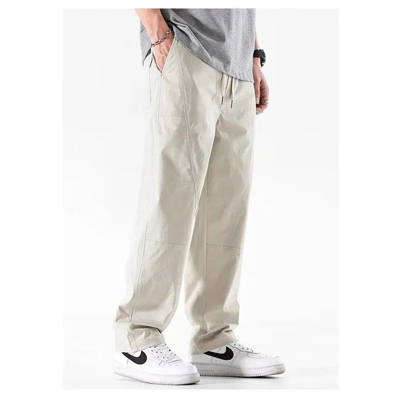 Beige cotton wide-leg casual trousers with elasticated waistband displayed flat