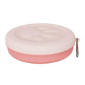 Collapsed and open views of a pink and green silicone portable dog bowl on a grassy background.