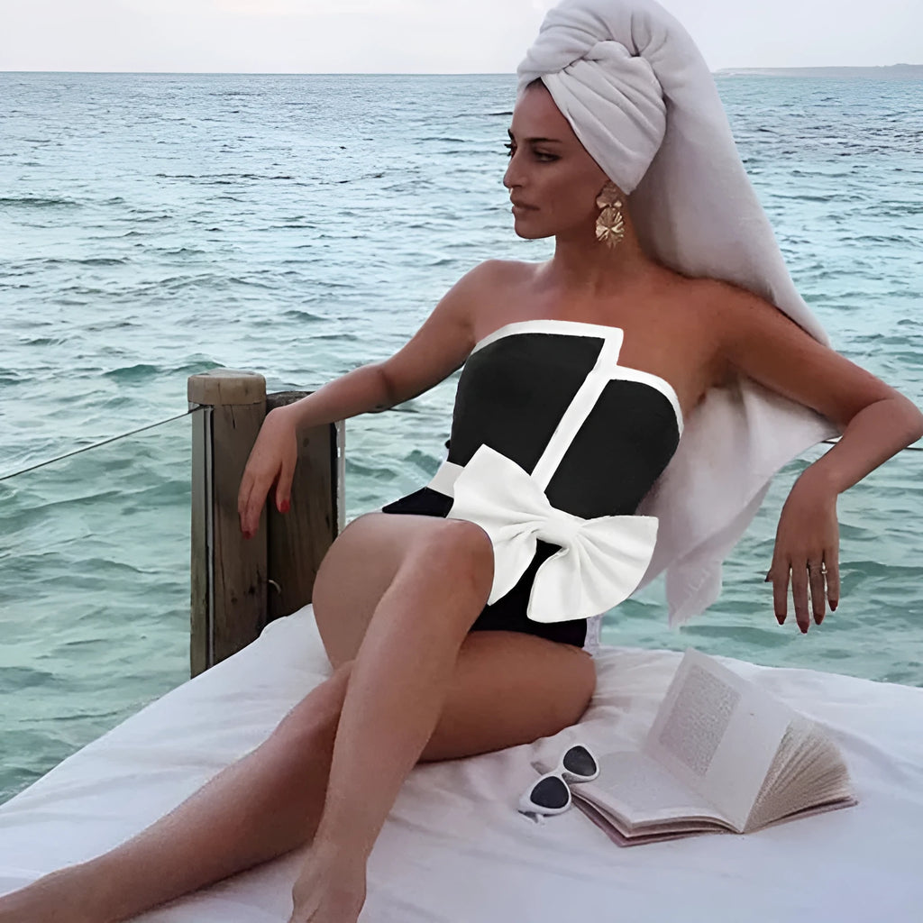 Women's black and white colour-block one-piece swimsuit with irregular tube top and bow detail