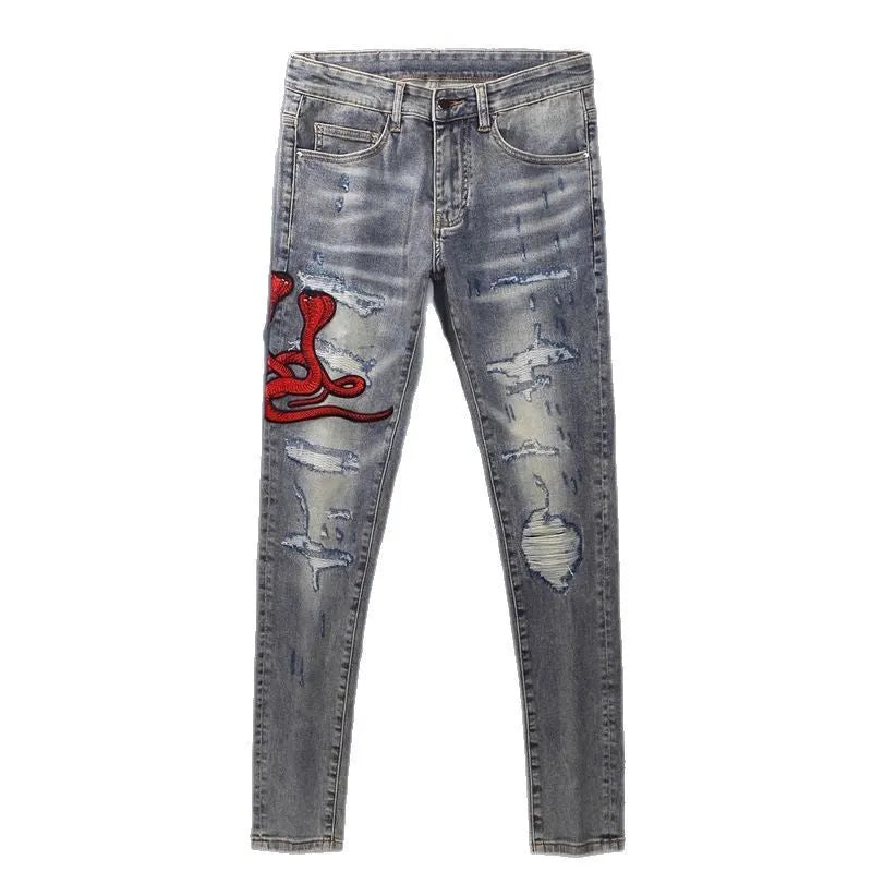 Men's slim fit distressed jeans with embroidered patches in old colour wash