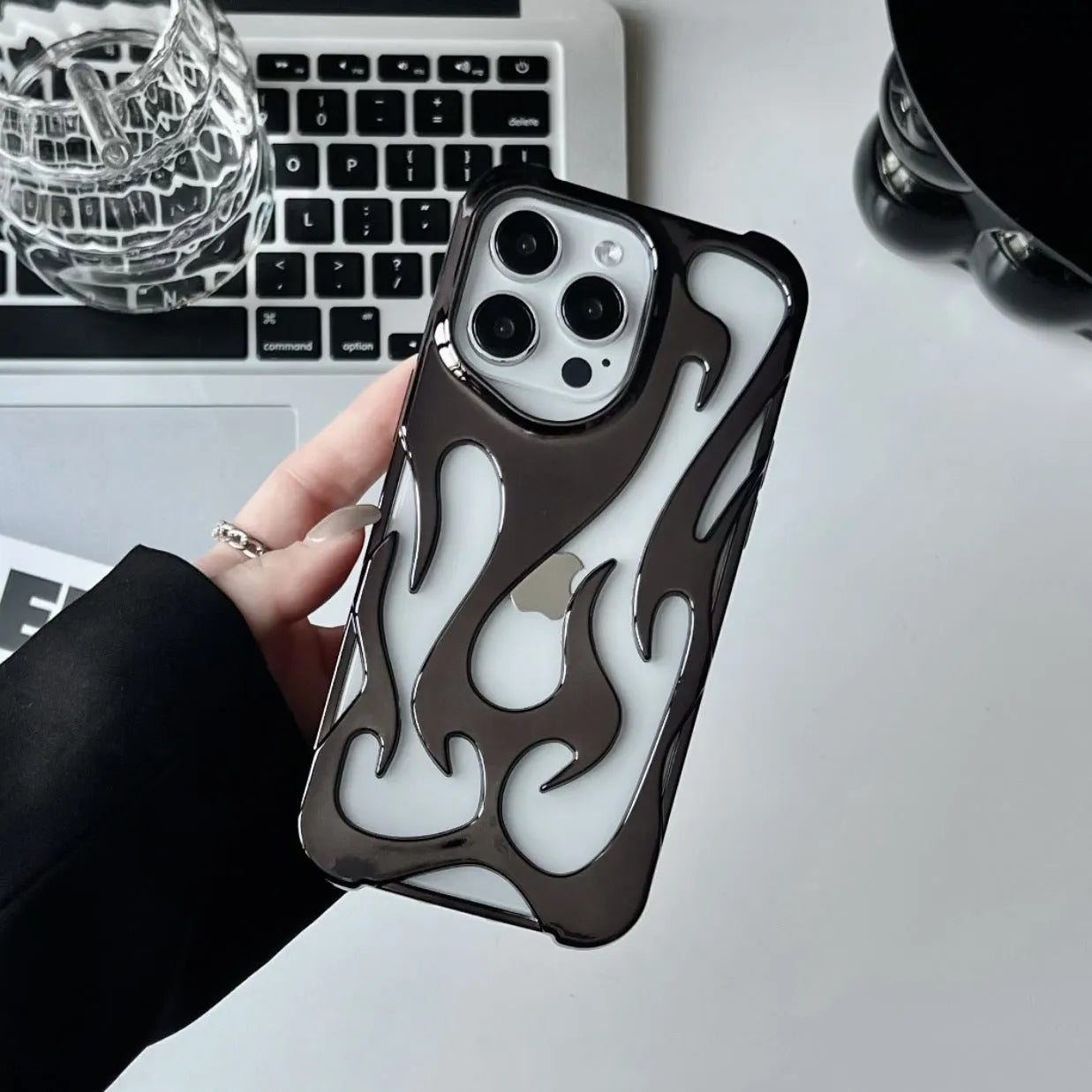 Electroplated hollow flame pattern soft phone case for Apple iPhone in silver finish.