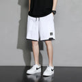 Boys' black cotton casual shorts with mid-waist, shown on a hanger.