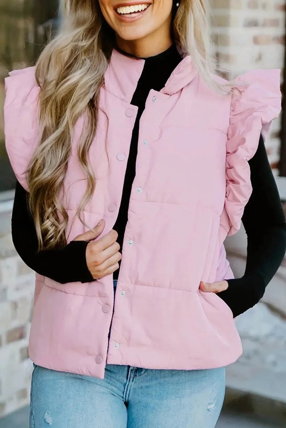 Pink polyester puffer vest with stand neck, flutter sleeves, and snap buttons – front view