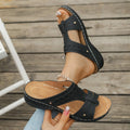 Pair of blue Roman-style slope heel slippers showing fish mouth toe holder design.