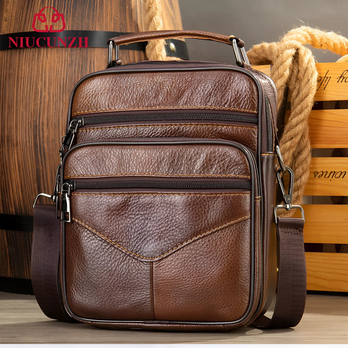 Men's top grain leather crossbody bag in brown with stitching detail and expandable side panels