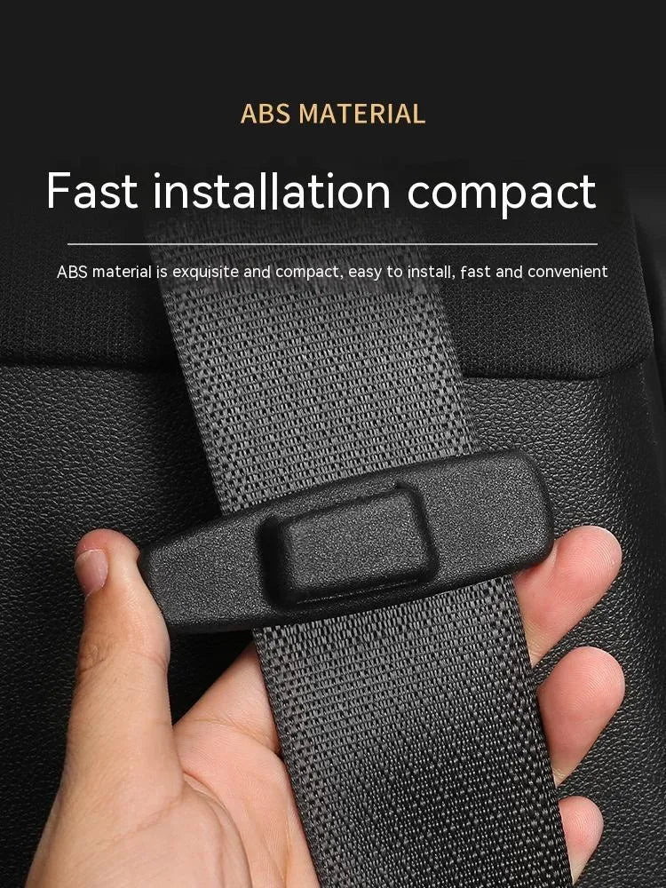 Two black ABS plastic universal seatbelt stopper clips shown next to a car seatbelt.