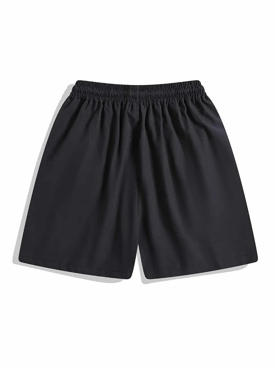 Man wearing loose-fitting black quick-dry sports shorts with an elastic waist for training.