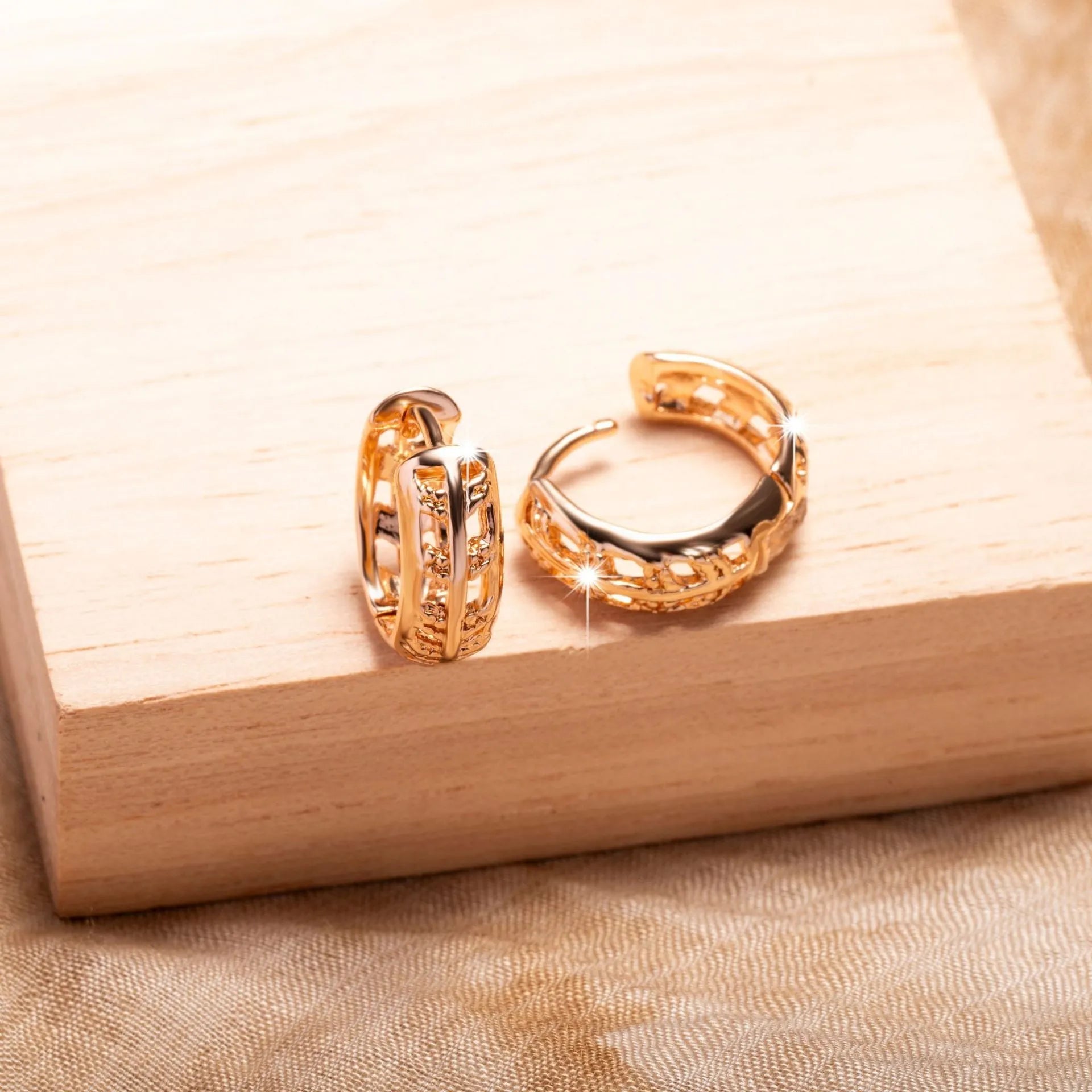 Hollowed-out copper earrings with leaf and heart designs in rose gold colour