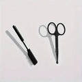 Black pet eye grooming brush with soft bristles and comb attachment for tear stain removal