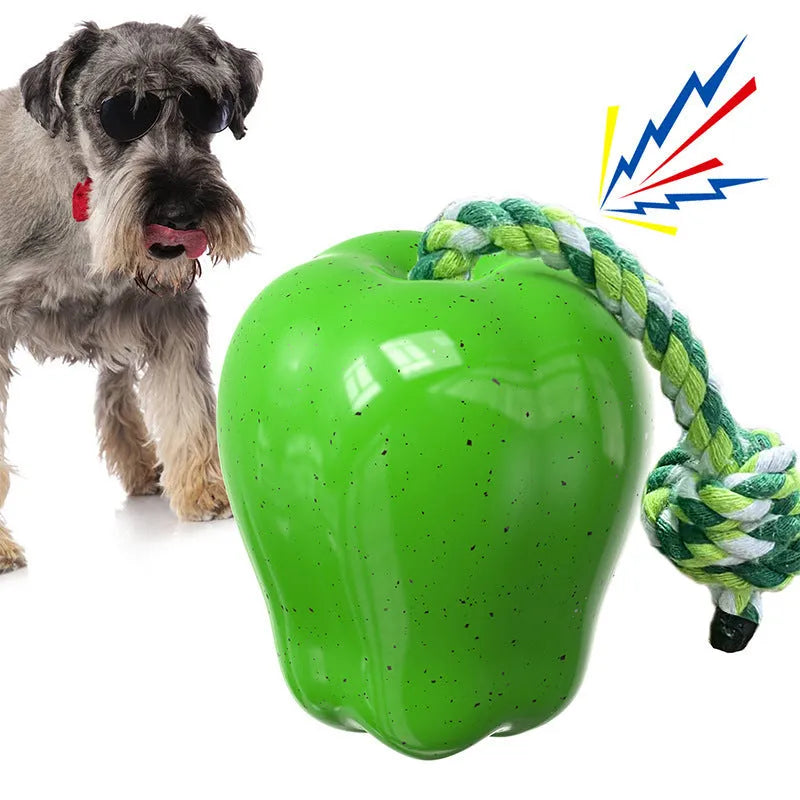 Green plastic apple-shaped dog toy with food dispensing openings for interactive feeding games