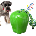 Green plastic apple-shaped dog toy with food dispensing openings for interactive feeding games