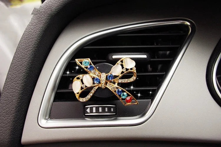 Alloy car perfume clip with liquid fruity scent attached to air vent in various cartoon styles