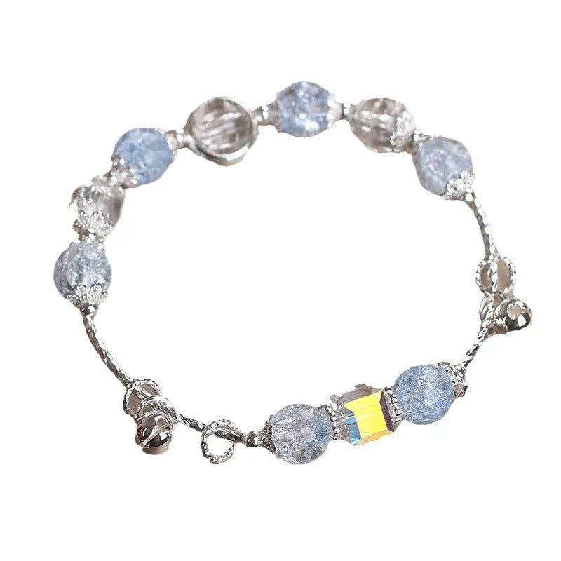Light blue artificial crystal bell bracelet on woman's wrist