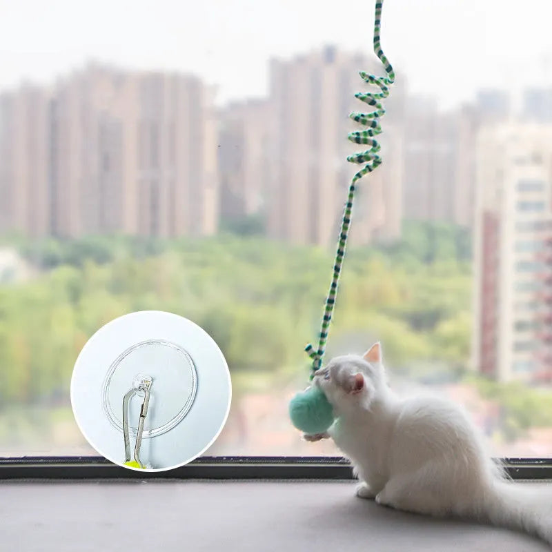 Hanging suction cup cat toy with colourful spring, inflatable ball, and bell for indoor cats