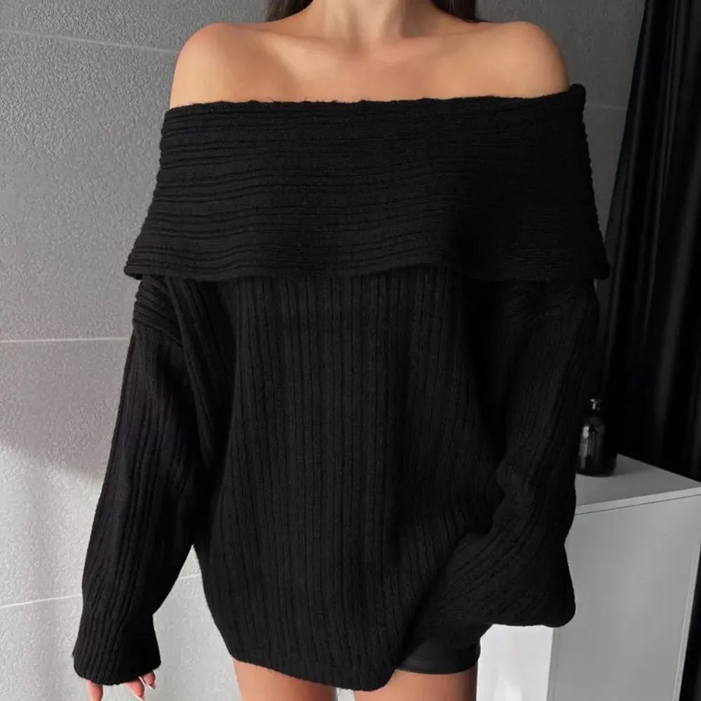 A woman wearing a loose, long-sleeved acrylic pullover sweater in a neutral colour.