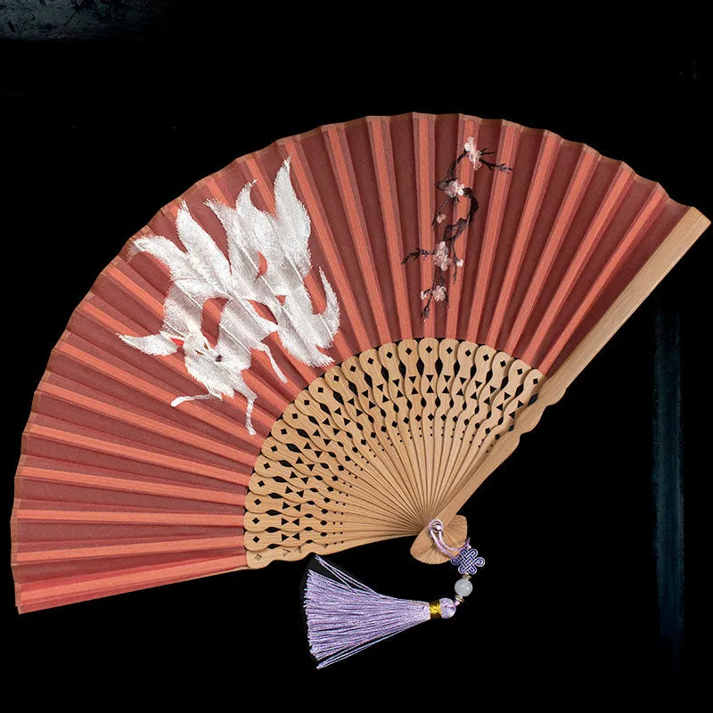 Traditional bamboo folding fan with embroidered butterfly and nine-tailed fox designs