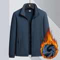 A man's thick grey Berber fleece coat with a zip front, stand-up collar, and drawstring sleeves.
