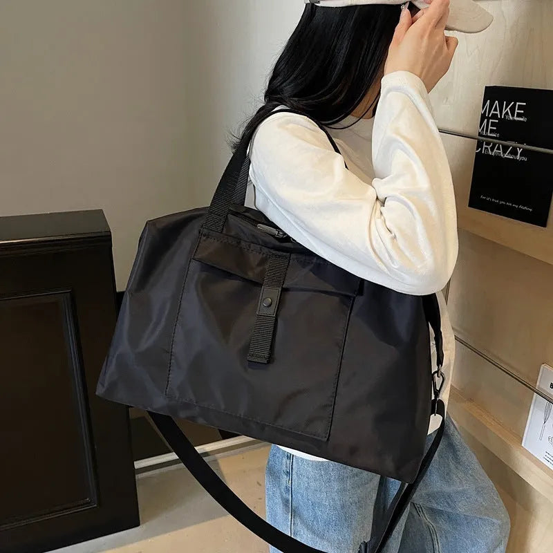 Grey one-shoulder travel bag with large 36-55 litre capacity and Oxford cloth construction