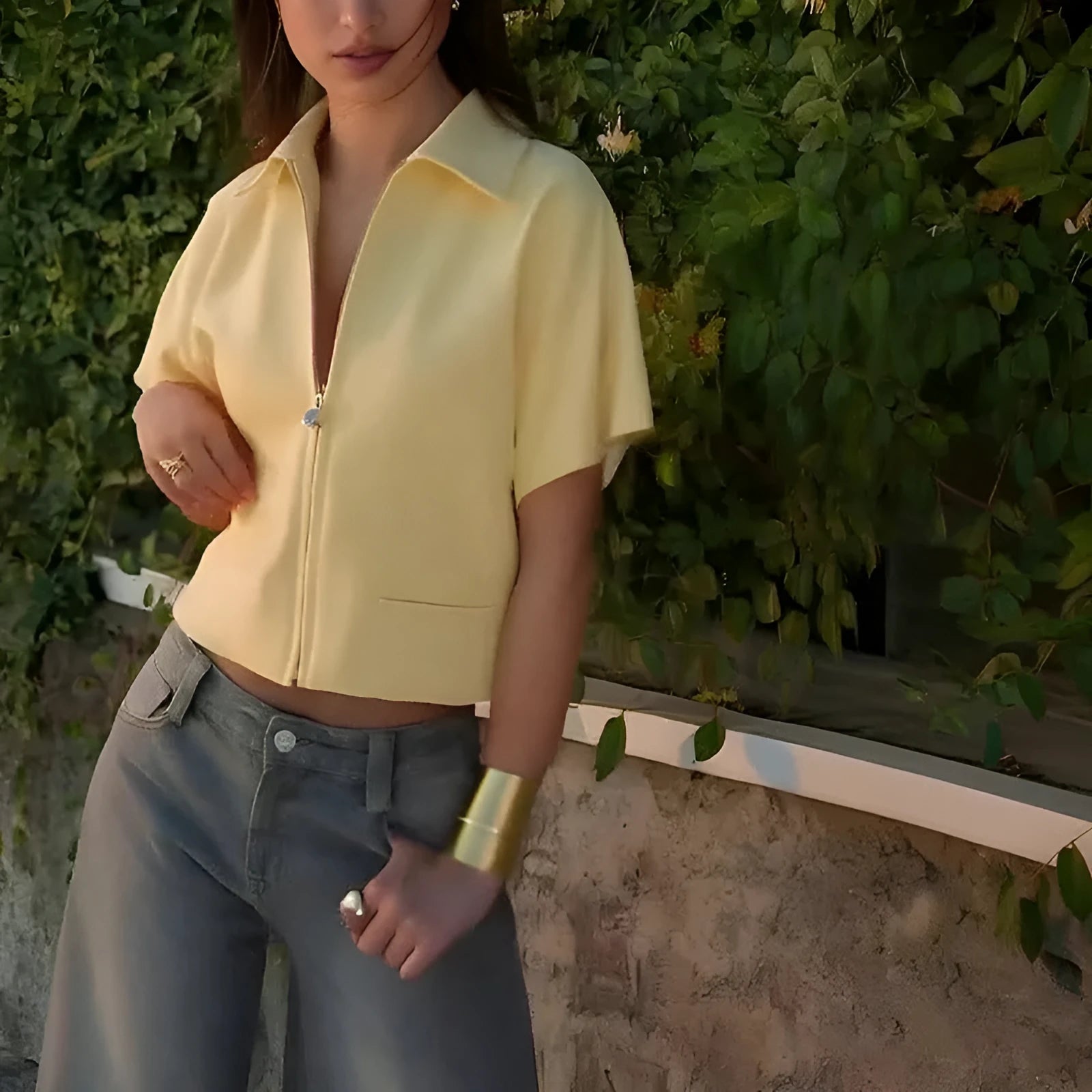 Man wearing a loose-fit yellow short sleeve casual polyester top.