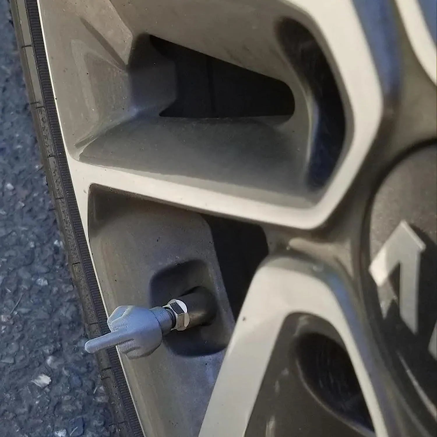 Four latex tyre valve caps shown in skin colour and black colours for dust protection