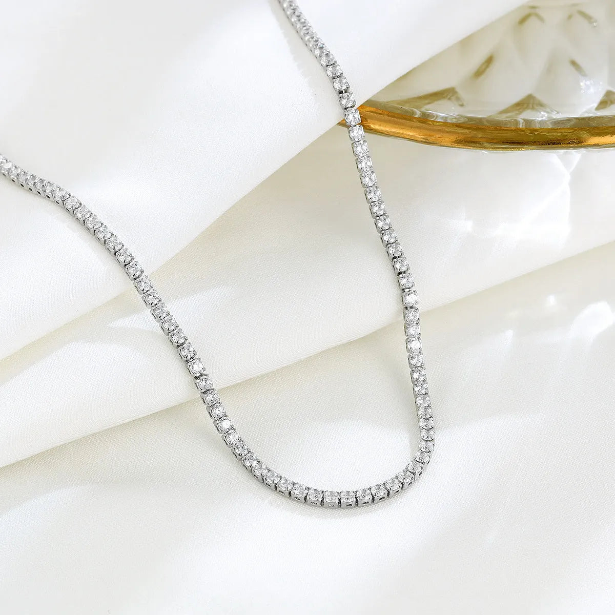 Women's sterling silver necklace with diamond-cut round pendant on fine chain