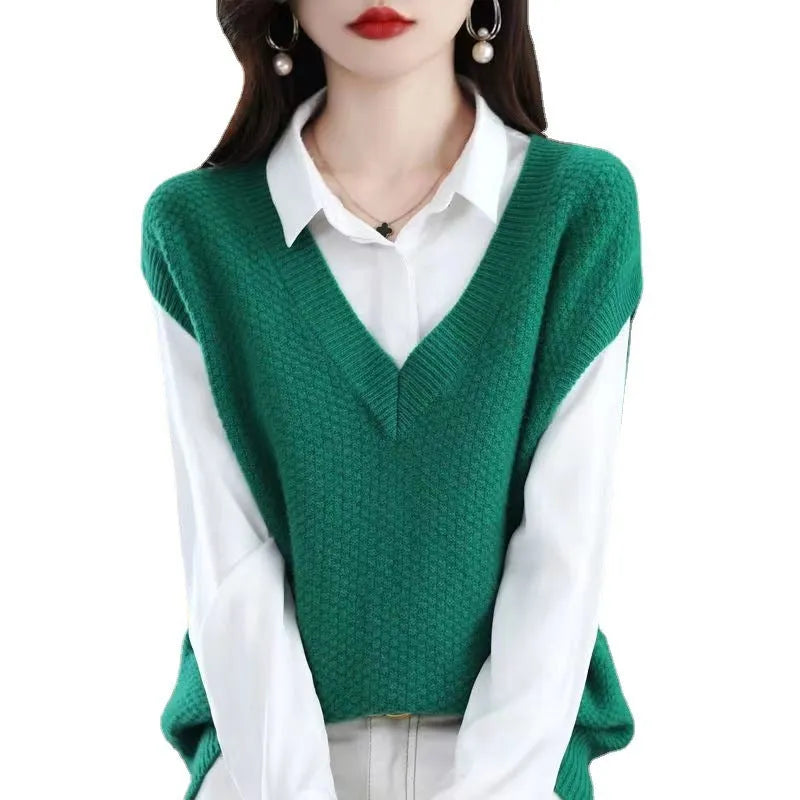 Women's creamy-white V-neck sleeveless knitted vest with a 3D pattern, laid flat.