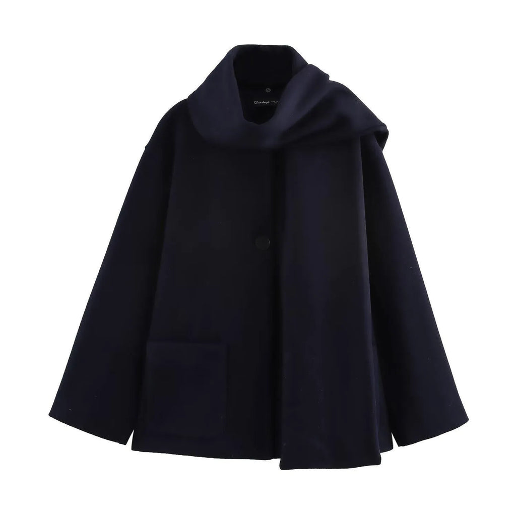 Women's long black overcoat with artificial fur collar, showing extended length and street fashion style.