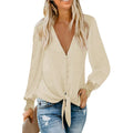 A loose-fitting, solid-colour V-neck top with long sleeves and a lace-up detail at the hem.