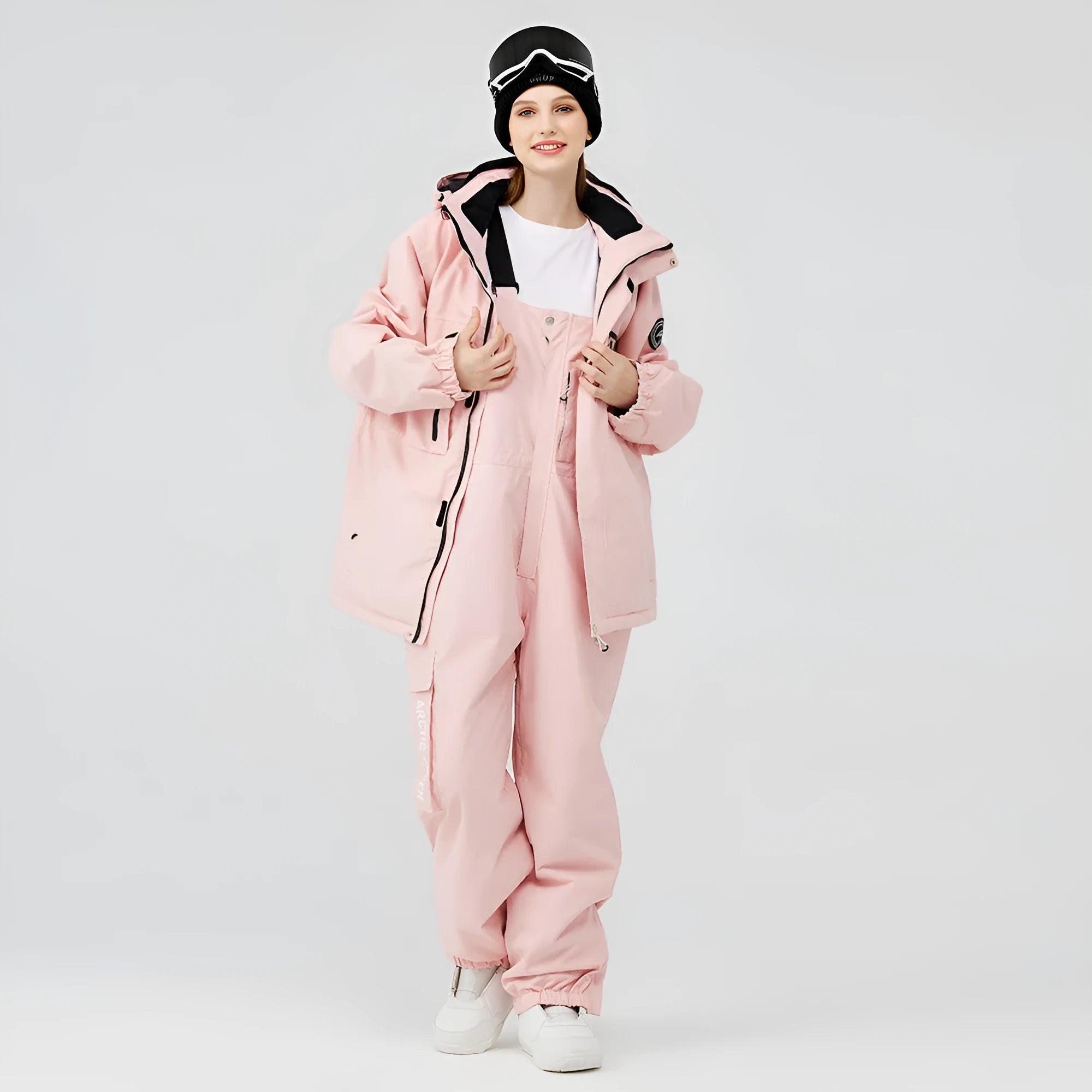 Blue and black two-piece ski suit for men and women on snowy mountain background