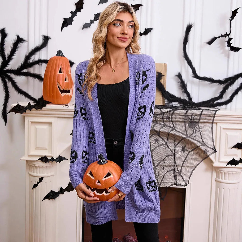 Women's black Halloween cardigan with orange Jacquard knitted pumpkin head pattern, shown on a hanger.