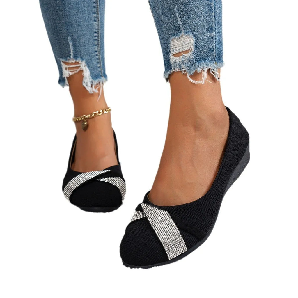 Black women's slip-on casual shoes with rhinestone detail on fabric upper and a short chunky heel.