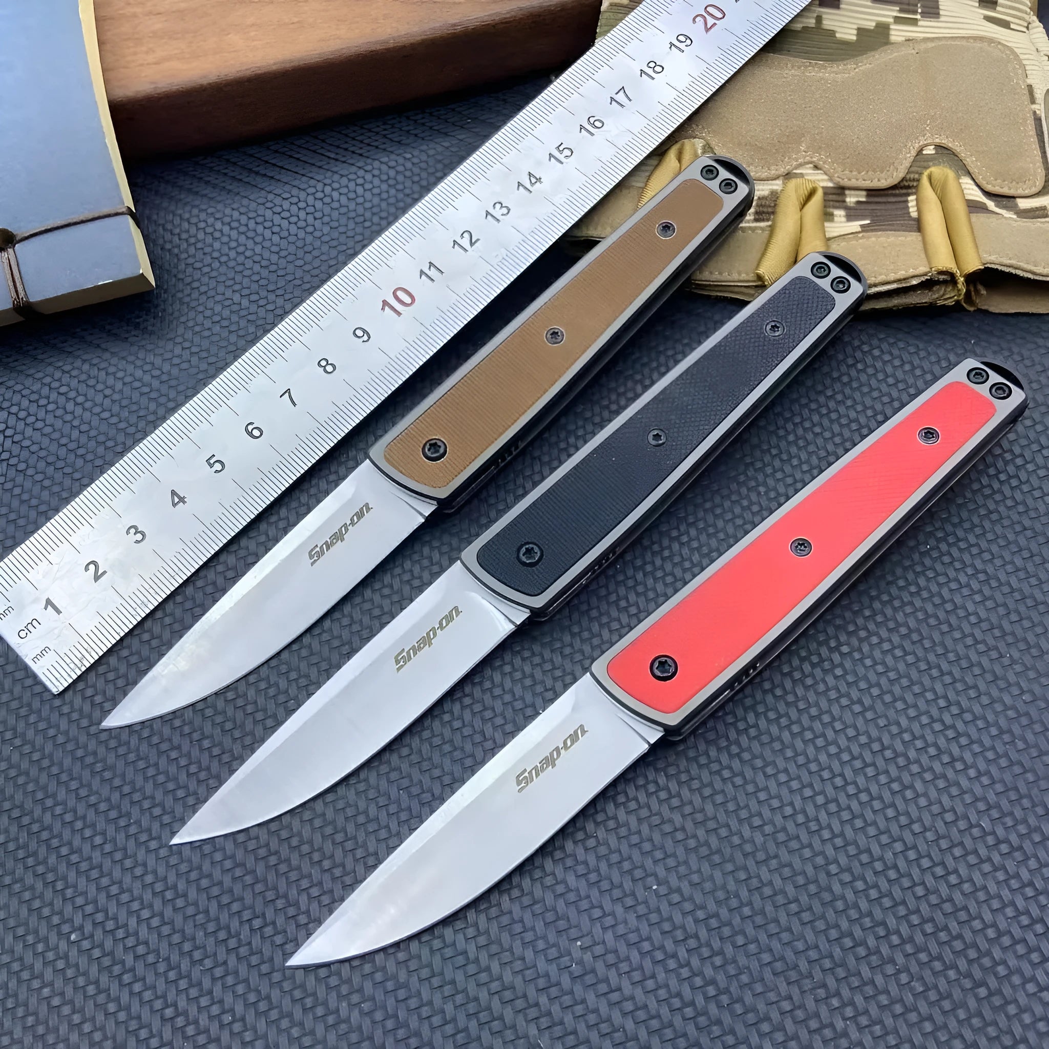 Closed and opened views of a black folding fruit knife showing the stainless steel blade and handle.