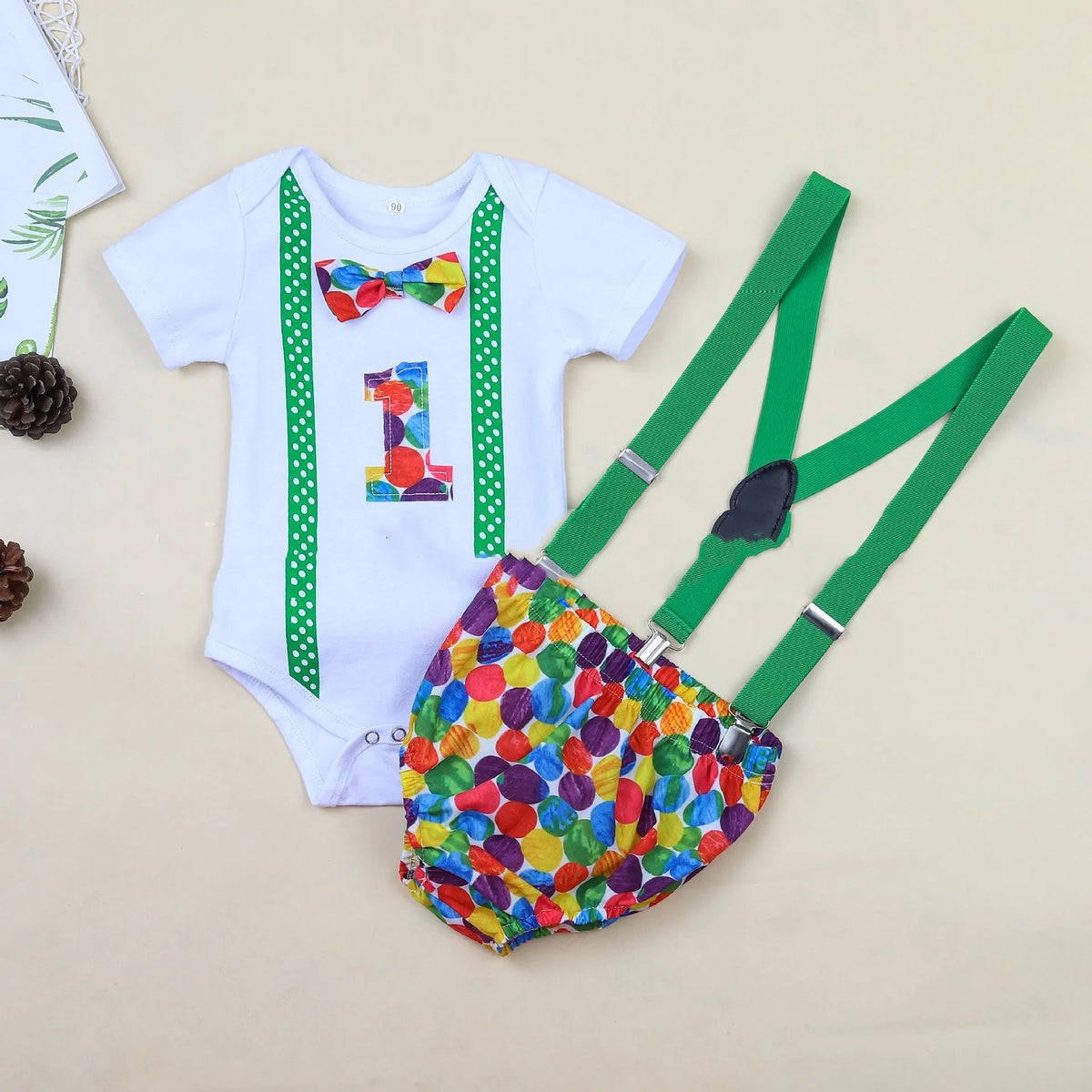 Baby in a soft cotton dinosaur print romper with shorts, showing the pullover design and clean finish.