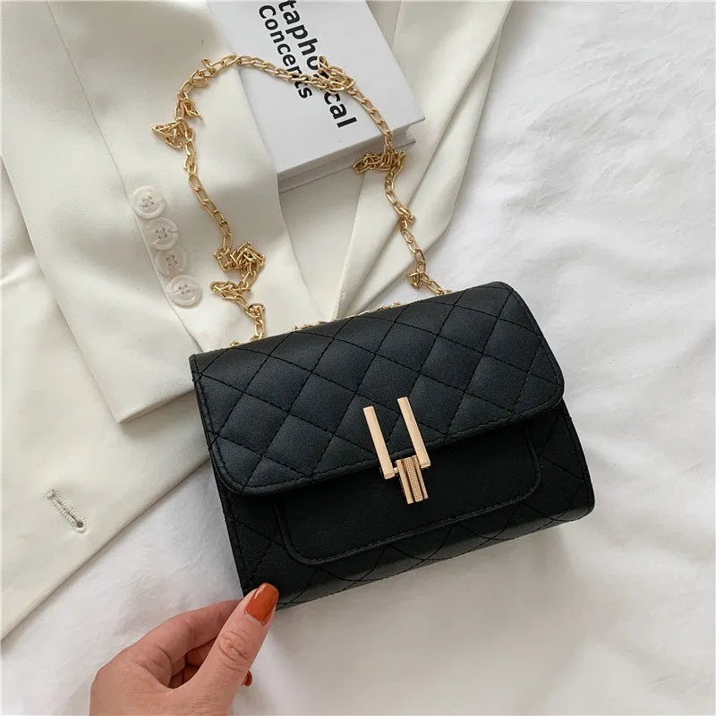 Women's black PU leather crossbody bag with diamond lattice chain detail and adjustable shoulder strap
