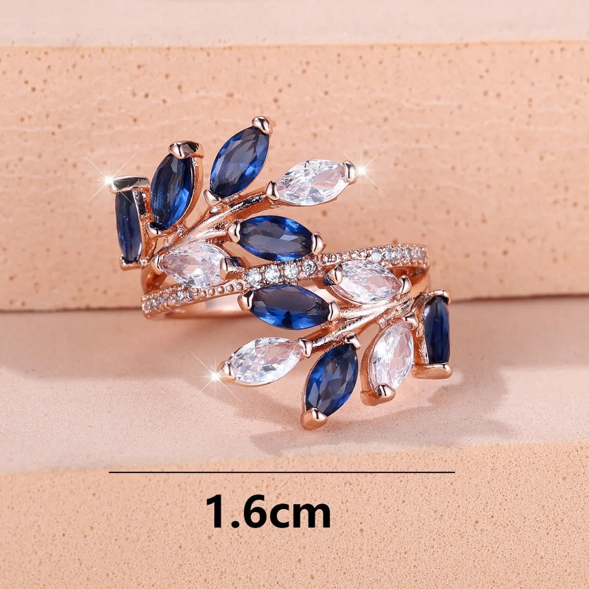 Adjustable leaf ring with horse eye zircon stone in rose gold finish on wooden background