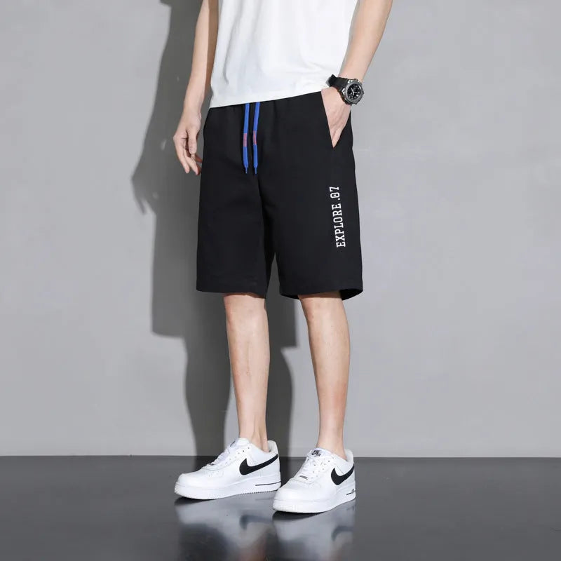 Boys' black cotton casual shorts with mid-waist, shown on a hanger.