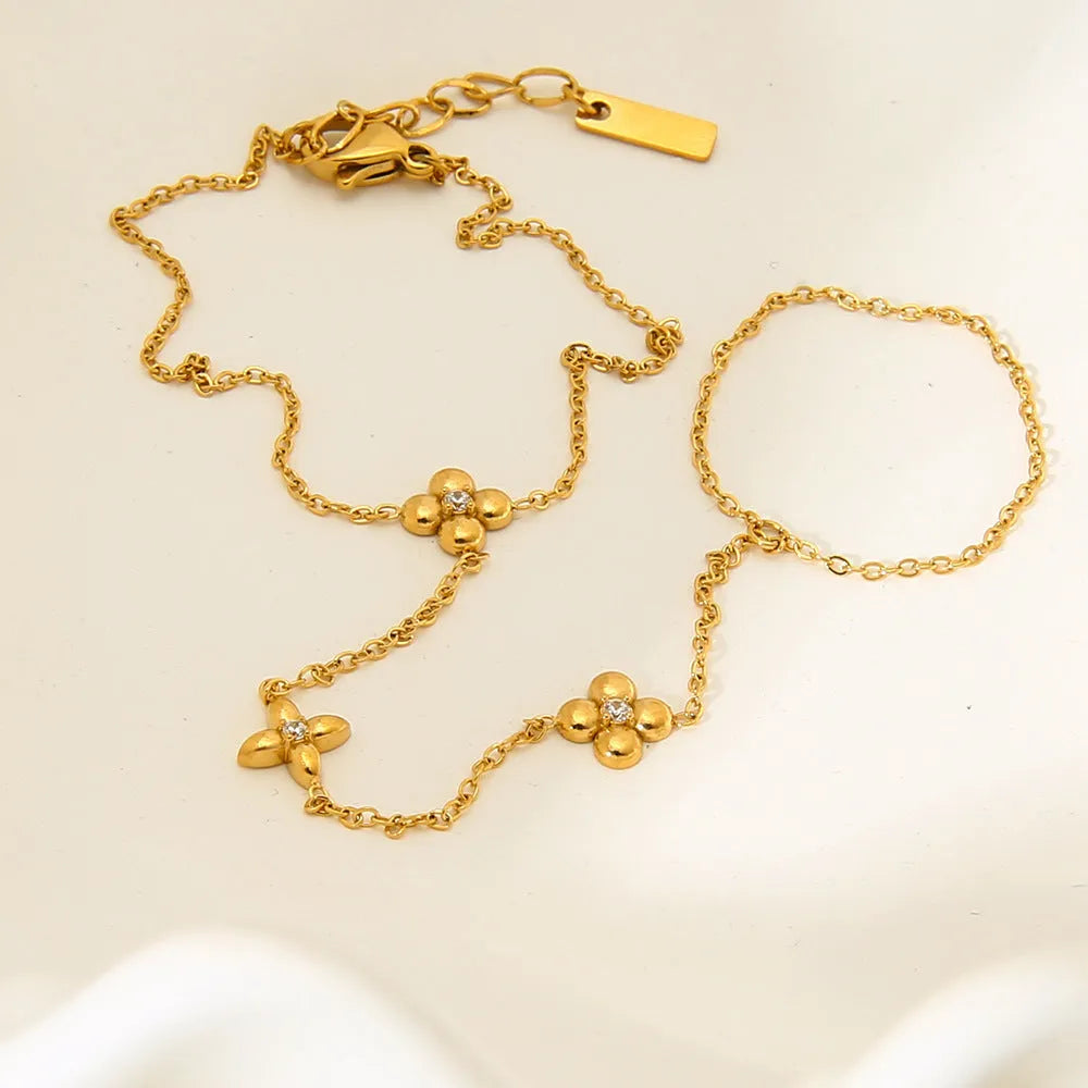 Gold-coloured stainless steel women's bracelet with geometric floral and eight-pointed star design.