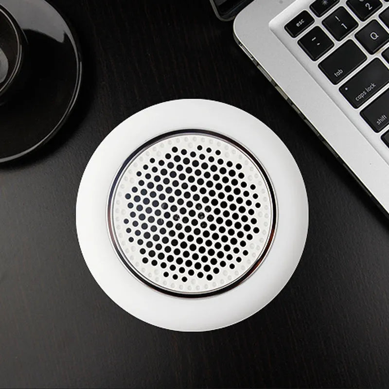 White mini portable Bluetooth sound light speaker with 5W output and touch controls on a surface