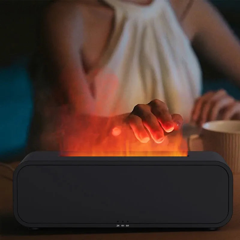 Black Flame Dynamic aroma diffuser with flickering light effect and remote control on a table.