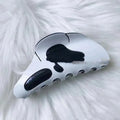 White plastic Halloween grimace barrette with 7 forks, 9.5x4x4.5cm, on white background