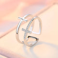Adjustable open copper ring with a double cross design featuring zircon stones in a sterling silver inlay.
