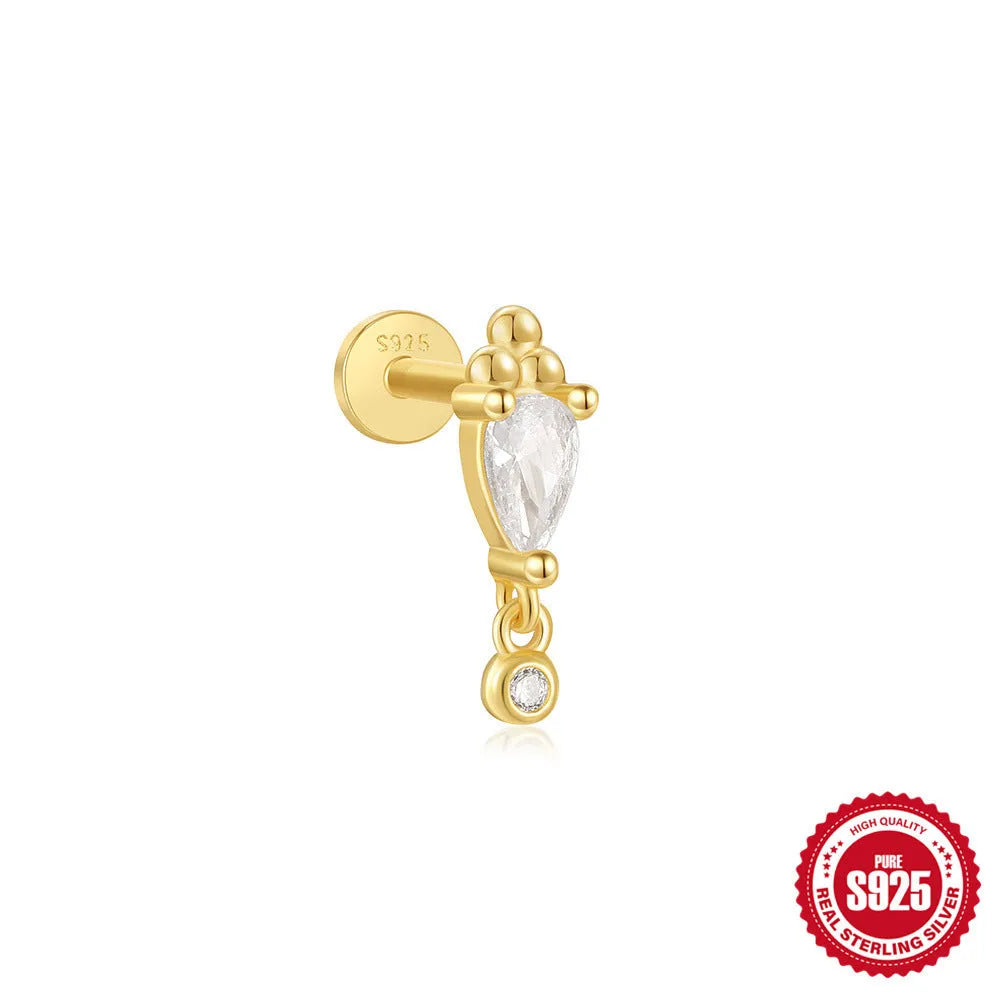 A gold tone sterling silver ear stud featuring a dangling tassel and XINGX inlaid design on the stud.